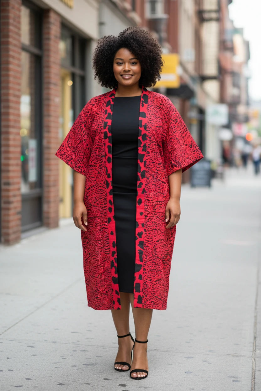 Model wearing an Akosua Hosi, LTD. longline red and black printed kimono over a black midi dress 