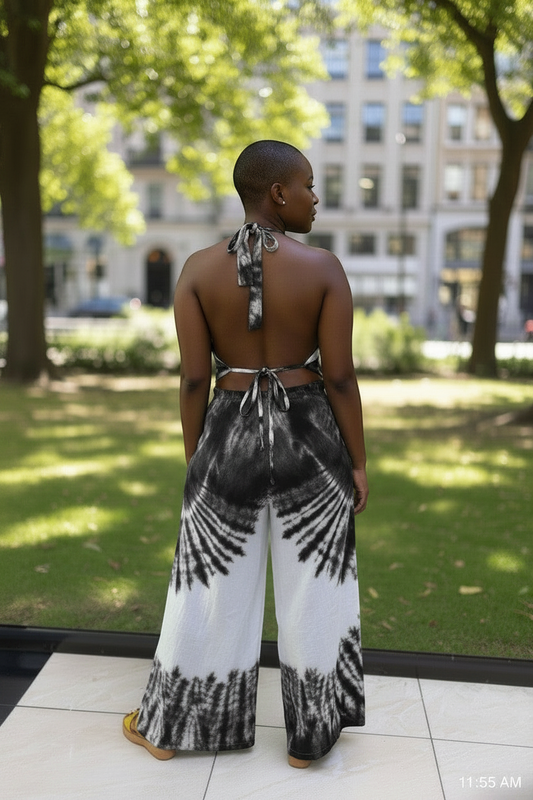 Akosua Hosi, LTD. black and white cotton batik two-piece set with halter tie-back top and wide-leg pants in a park.